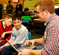 ISU student helps fourth graders program
computer-run cars.