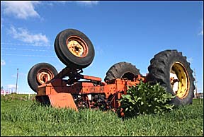overturned tractor in a farm field
