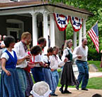 Square dancers outside of the Farm House