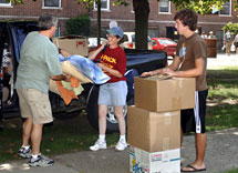 Staff members helps student move in.