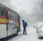Passenger gets on bus during blizzard