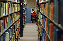 Student studies in library carrel.