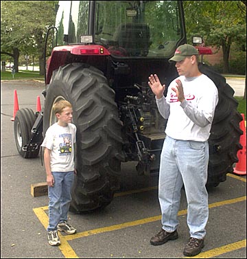 two people in front of a tractor