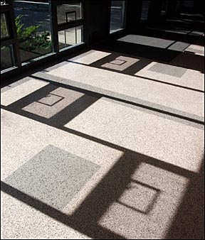 shadows formed on the floor by sun shining through windows