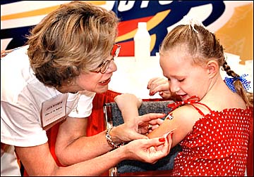 Judy Minnick applying Cy tattoo