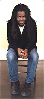 Tracy Chapman sitting in a chair