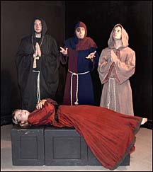 Monks standing around a dead female