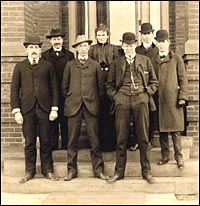 civil engineering group, 1901, one woman and six
men in suits, ties and hats