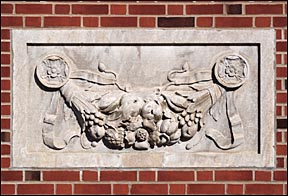 a relief cornucopia on a brick wall
