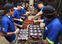 Attendees at the State 4-H Youth Conference
assemble pans of lasagna