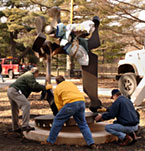 Men placing large sculpture