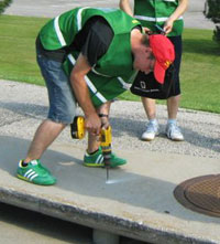 Volunteer installs a marker near storm drain.