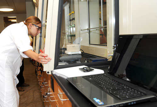 Student works on high-tech equipment in Hach Hall